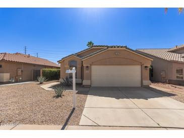 Charming single-story home with a well-maintained front yard and attached two-car garage at 9423 E Posada Ave, Mesa, AZ 85212