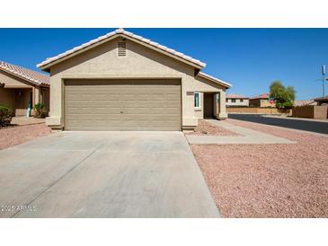 Charming single-story home featuring a two-car garage and low maintenance desert landscaping at 12240 W Scotts Dr, El Mirage, AZ 85335