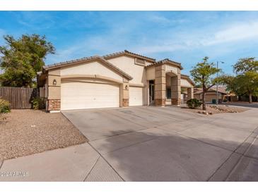 Charming single-Gathering home with a spacious three-car garage and a well-maintained desert landscape at 16510 W Baden Ave, Goodyear, AZ 85338