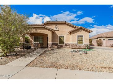 Charming single-story home with a well-maintained landscape, stone accents, and covered porch at 21752 E Domingo Rd, Queen Creek, AZ 85142