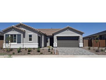 Charming single story home with a two car garage, stone landscaping and a low maintenance desert yard at 24134 N 172Nd Ave, Surprise, AZ 85387