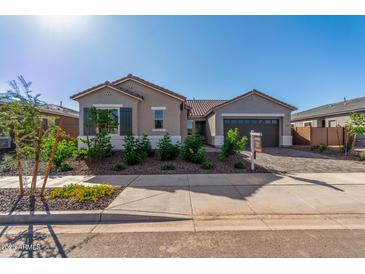 Charming single-story home with desert landscaping, a two-car garage, and a tile roof at 24134 N 172Nd Ave, Surprise, AZ 85387