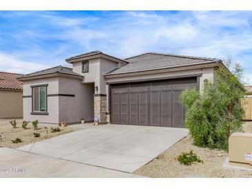 Well-maintained one story home featuring a two car garage and a desert landscaped front yard at 24408 W Ripple Rd, Buckeye, AZ 85326
