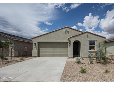 Charming single-story home featuring a neutral stucco facade, a two-car garage, and desert landscaping at 2514 E Music Mountain Ave, Apache Junction, AZ 85119