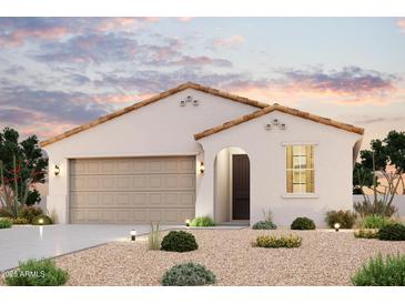 Charming single-story home boasting a stucco facade, tile roof, arched entryway, and a meticulously xeriscaped front yard at 2514 E Music Mountain Ave, Apache Junction, AZ 85119