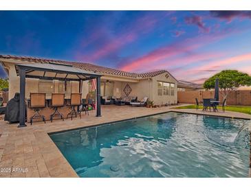 Backyard pool and patio area with outdoor seating, ideal for relaxing and entertaining in the Arizona heat at 3690 E Blue Spruce Ln, Gilbert, AZ 85298