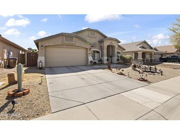 Charming single-story home with a two car garage and a well-maintained desert landscaped front yard at 40729 W Coltin Way, Maricopa, AZ 85138