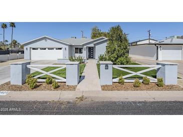 Charming home exterior featuring a well-manicured lawn and stylish fence, creating an inviting curb appeal at 4402 E Montecito Ave, Phoenix, AZ 85018