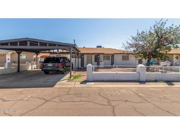 Charming single-story home with a covered carport and quaint, low-walled front yard at 4521 W Clarendon Ave, Phoenix, AZ 85031