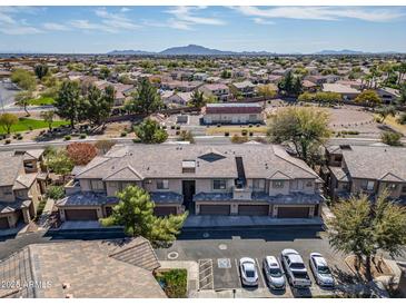 Aerial view showcasing the layout of the community with homes, mature trees, landscaping, and parking areas at 705 W Queen Creek Rd # 1201, Chandler, AZ 85248