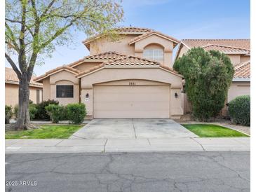 Charming two-story home featuring a two-car garage, well-maintained landscaping, and a classic tile roof at 7931 W Shaw Butte Dr, Peoria, AZ 85345