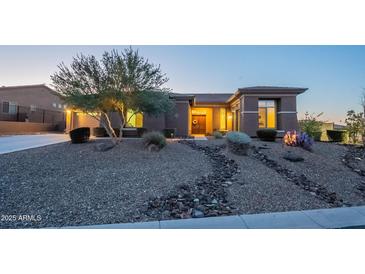 Charming single-story home with desert landscaping, stone accents, and warm inviting entryway at 8504 S 30Th St, Phoenix, AZ 85042