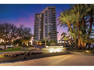 Stunning high-rise condo building in a tropical setting with lush landscaping and vibrant evening sky at 1040 E Osborn Rd # 203, Phoenix, AZ 85014