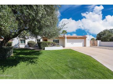 Charming single-story home featuring a well-manicured lawn and an attached two-car garage at 11221 N 32Nd St, Phoenix, AZ 85028