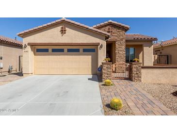 Charming single-story home with stucco exterior, attached garage, and inviting front entryway with landscaped yard at 18182 W Glenhaven Dr, Goodyear, AZ 85338