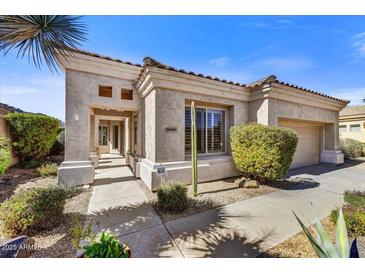 Charming single-story home featuring a desert-style landscape, stucco facade, and a tiled roof in a sunny, inviting setting at 26560 N 115Th St, Scottsdale, AZ 85255