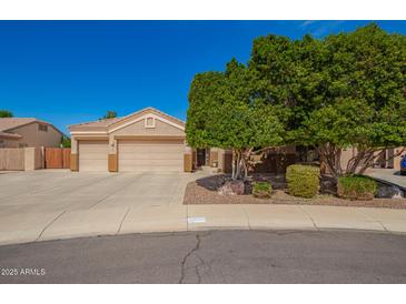 Charming single-Gathering home featuring a three-car garage, desert landscaping, and mature shade tree at 3562 E Harvard Ct, Gilbert, AZ 85234