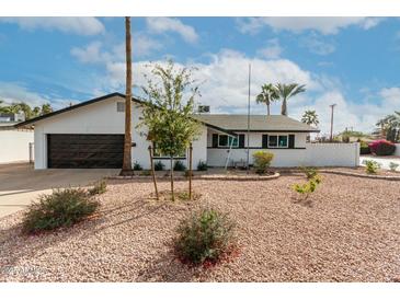 Charming single-story home featuring a well-maintained desert landscape and attached garage at 501 E Hermosa Dr, Tempe, AZ 85282