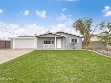 Charming single-story home featuring a lush green lawn and a well-maintained exterior at 901 W 16Th St, Tempe, AZ 85281