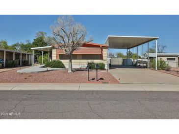 Inviting home with covered parking, desert landscaping and charming curb appeal at 17244 N 66Th Ln, Glendale, AZ 85308