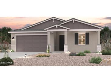 Charming single-story home with a two-car garage and desert landscaping in the front yard at 18035 W Camino De Oro --, Surprise, AZ 85387