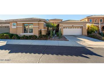 Inviting home featuring a desert landscape, tile roof, and a convenient two-car garage at 2325 W Mineral Rd, Phoenix, AZ 85041