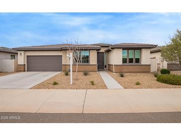 Inviting single-story home with a two-car garage and low maintenance desert landscaping at 39758 N Hailey Ln, Queen Creek, AZ 85140