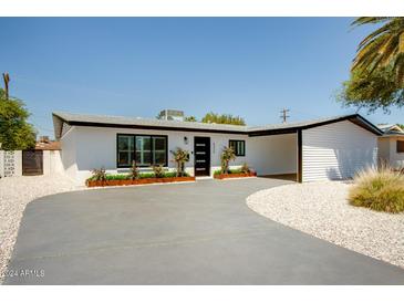 Charming single-story home boasts a modern design with well-manicured landscaping and a spacious driveway at 6326 N 86Th N St, Scottsdale, AZ 85250