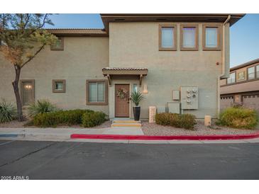 Inviting condo exterior featuring a private front door, well-maintained landscaping, and convenient parking at 1225 N 36Th St # 2101, Phoenix, AZ 85008