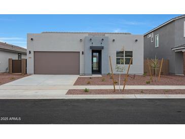Contemporary single-story home featuring a two-car garage, modern design, and drought-tolerant landscaping at 17307 W Via Dona Rd, Surprise, AZ 85387
