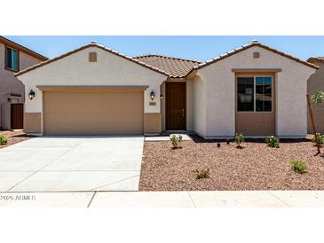 Charming single-story home featuring desert landscaping, a two-car garage, and a covered entryway at 17547 W Lupine Ave, Goodyear, AZ 85338