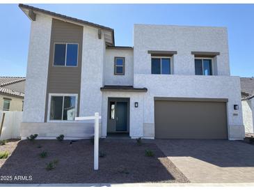 Beautiful two-story home with modern design, desert landscaping, and a two car garage at 18035 W Vogel Ave, Goodyear, AZ 85338