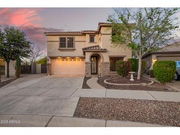 Charming two-story home featuring desert landscaping, stone accents, arched entryway, and a two car garage at 21784 E Puesta Del Sol --, Queen Creek, AZ 85142