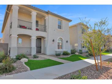 Charming two-story home featuring dual balconies, a landscaped front yard, and a welcoming covered entryway at 2601 S Entwistle St, Gilbert, AZ 85295