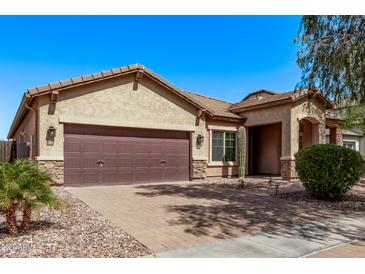 Charming single-story home featuring a two-car garage and desert landscaping at 3044 E Trigger Way, Gilbert, AZ 85297