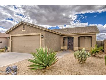 Charming single-story home showcasing desert landscaping and a two-car garage at 30718 N Coral Bean Dr, San Tan Valley, AZ 85143