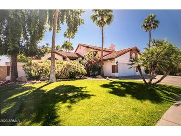 Charming single-Gathering home features a well-manicured lawn, mature trees, and inviting curb appeal at 41 S Honeysuckle Ln, Gilbert, AZ 85296