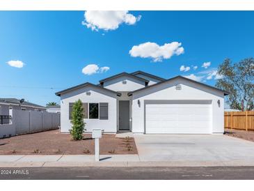 Charming single-story home boasts a two-car garage and desert landscaping at 410 S 98Th Pl, Mesa, AZ 85208