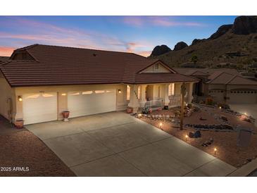 Charming single-story home featuring a three-car garage, desert landscaping, and mountain views at 4846 S Rimrock Loop, Gold Canyon, AZ 85118