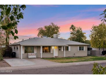 Charming single-story home with a well-maintained lawn and a welcoming front entrance at 7729 E Catalina Dr, Scottsdale, AZ 85251