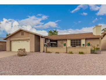 Charming single-story home with a well-maintained yard and an attached two-car garage at 980 Leisure World --, Mesa, AZ 85206