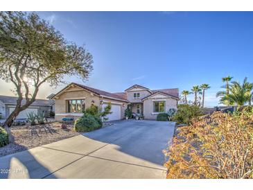 Beautiful single-Gathering home with desert landscaping, long driveway, and two-car garage at 1157 W Desert Lily Dr, San Tan Valley, AZ 85143