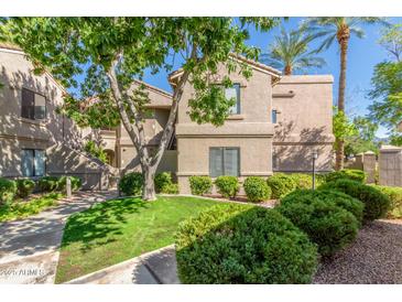 Charming two-story condo showcasing well-maintained landscaping and beautiful curb appeal at 15252 N 100Th St # 1156, Scottsdale, AZ 85260