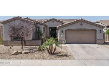 Charming single-story home with desert landscaping, tile roof, and attached two-car garage at 16492 N 181St Dr, Surprise, AZ 85388