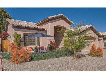 Charming single story home with inviting outdoor seating area and manicured landscaping in front yard at 1966 E Drake Dr, Tempe, AZ 85283