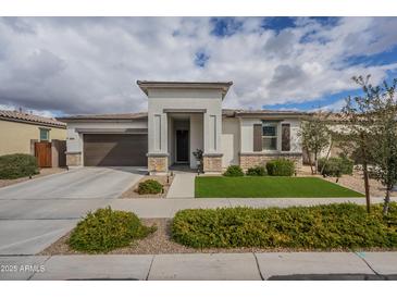 Charming single-story home featuring a manicured lawn, a two-car garage and a welcoming entryway at 22864 E Via Del Sol --, Queen Creek, AZ 85142