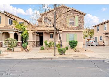 Charming two-story home featuring stone accents, desert landscaping, and neutral color palette at 34916 N 31St Ave, Phoenix, AZ 85086