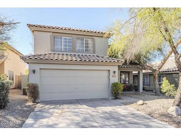 Charming two-story home with a well-maintained front yard and attached two-car garage at 4033 E Wildcat Dr, Cave Creek, AZ 85331