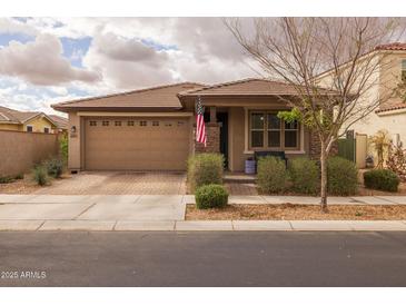 Charming single-story home with a well-manicured front yard and a two-car garage and tile roof at 10617 E Durant Dr, Mesa, AZ 85212