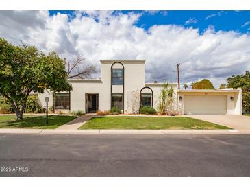 Stunning two-story home featuring a well-manicured lawn and attached two car garage at 1327 W Glendale Ave, Phoenix, AZ 85021